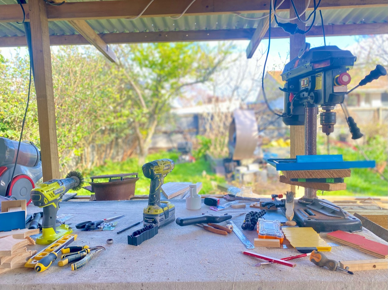 Tools and materials spread across the open-air workshop bench.